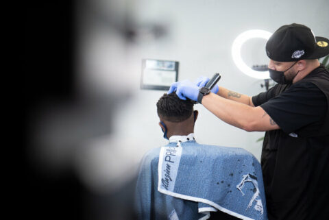 Barber working on a client at the studio